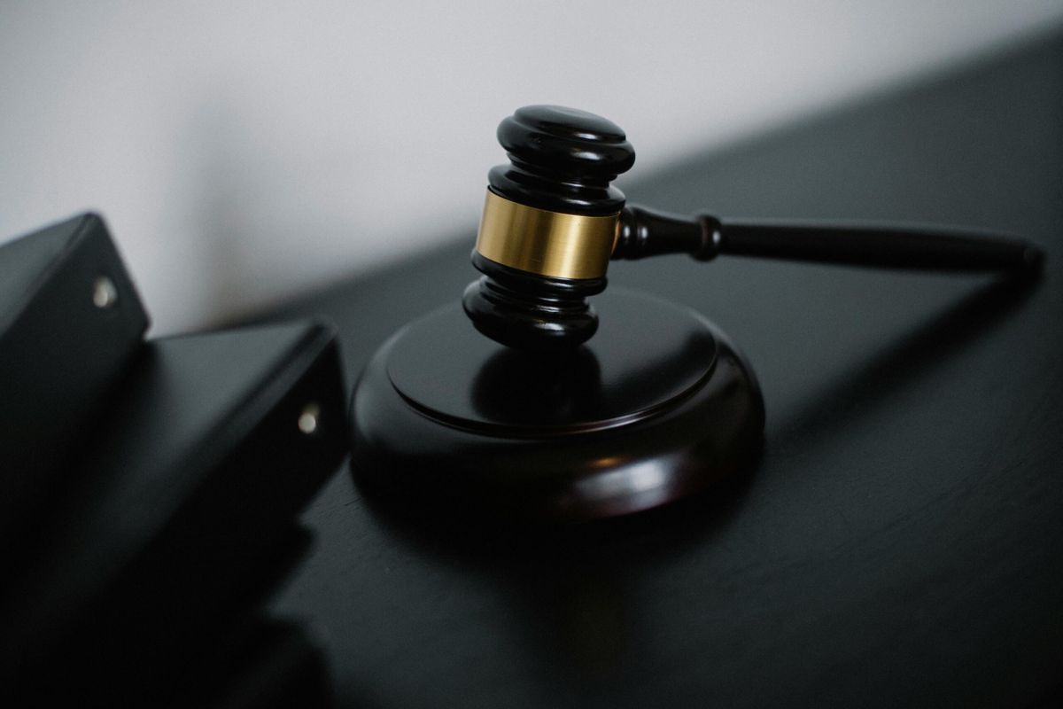 Judge's gavel on a dark desk