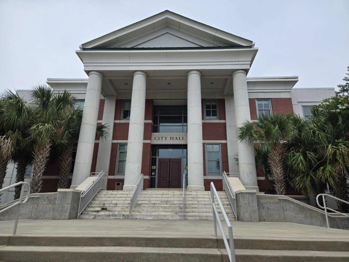 Columned government building with palm trees